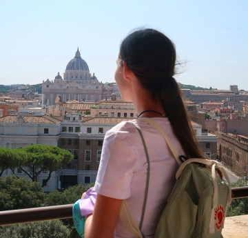 Student looking off a balcony